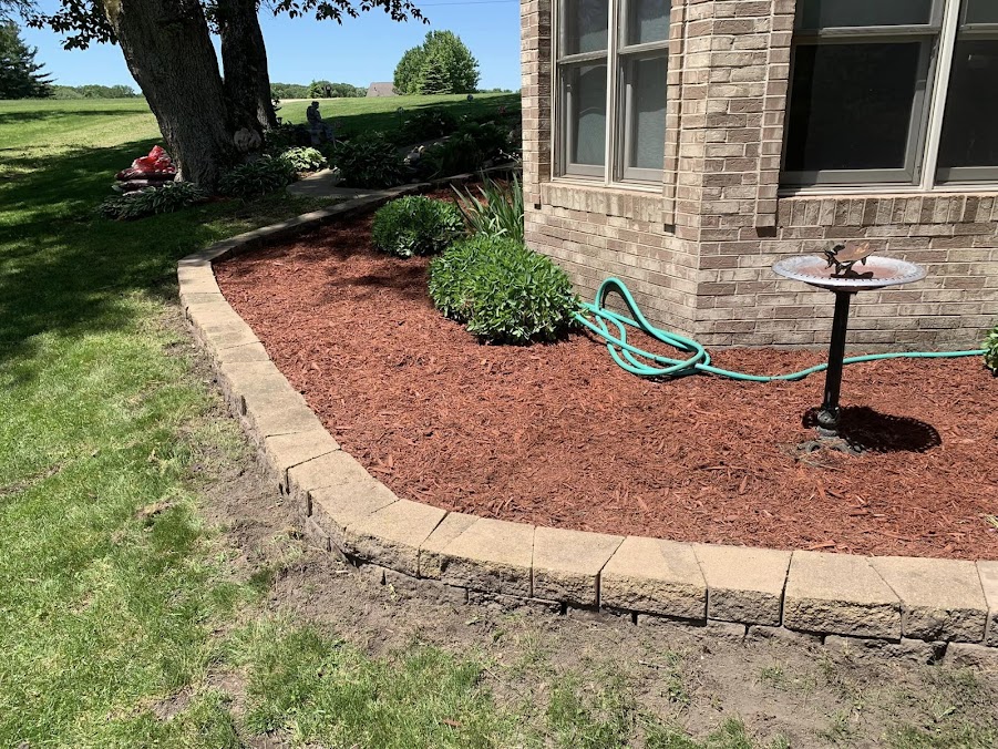 Fresh mulch bed and stone edging completed by Hernandez Landscape & Tree Service LLC